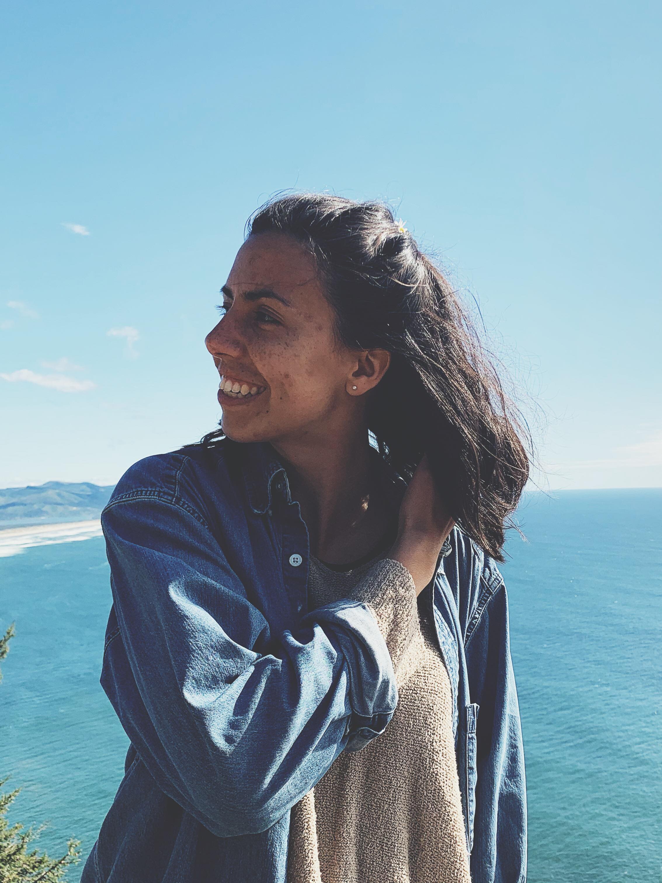 Shelby Hanson smiling on a coastal overlook